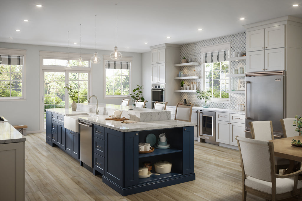 Modern kitchen with white shaker cabinets and navy blue island, stainless steel appliances, and wooden flooring.