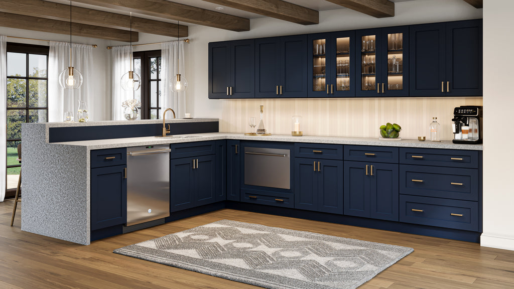 Modern shaker kitchen with navy blue cabinets, white countertops, and wooden flooring.